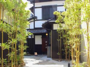 einen Innenhof mit Bambusbäumen vor einem Gebäude in der Unterkunft Ryokan Tanoya in Kyoto