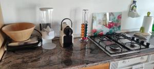 a kitchen counter with a stove and other items on it at Bellavista in Santorso +18 photos