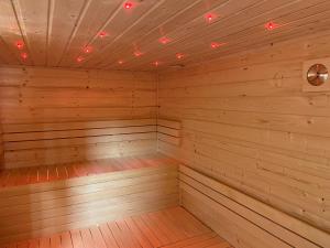 an empty wooden sauna with lights on the ceiling at Penzion Netolice in Netolice