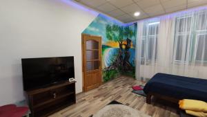 a bedroom with a painting on the wall and a television at Cluj Center in Cluj-Napoca
