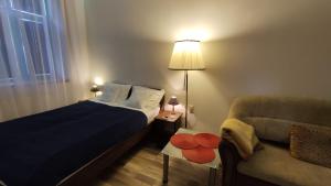 a small bedroom with a bed and a chair at Cluj Center in Cluj-Napoca
