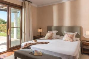 a bedroom with a large white bed and a window at Villa Violeta in Benalup Casas Viejas +16 photos