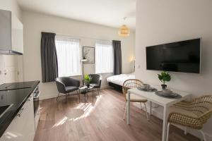 a kitchen and living room with a table and chairs at Boutique Scheveningen beach apartment in Scheveningen