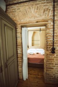 a room with a bed in a brick wall at Calista Liston Corfu Apartment in Corfu Town