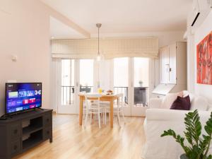 a living room with a table and a couch at LETS HOLIDAYS Attractive apartment in costa brava in Tossa de Mar