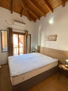 a bedroom with a large bed in a room at Romantic maisonette in the heart of Pythagoreio RH door in Pythagoreio