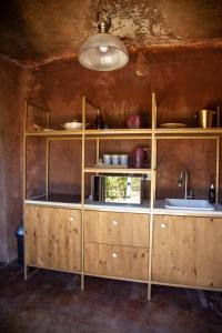 a kitchen with wooden cabinets and a sink at Le Héritage in Klein-Drakenstein