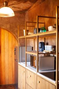 a kitchen with wooden cabinets and shelves in a room at Le Héritage in Klein-Drakenstein