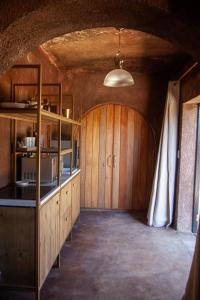 a room with a kitchen with wooden cabinets and a ceiling at Le Héritage in Klein-Drakenstein