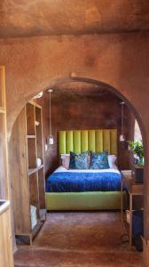 a bedroom with a bed in a room with an archway at Le Héritage in Klein-Drakenstein