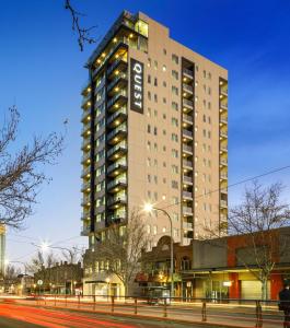 a tall building with a sign on the side of it at Quest King William South in Adelaide