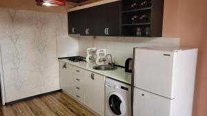 a kitchen with a white refrigerator and a sink at Квартира около мед центра Астхик in Yerevan