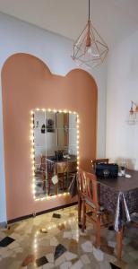 a dining room with a mirror and a table at La Casa di Jennifer in Parma
