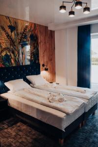 Posteľ alebo postele v izbe v ubytovaní Avangarda