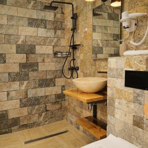 a bathroom with a bowl sink and a shower at Piata Unirii Central Apartments in Iaşi +56 photos