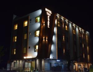 a hotel building at night with its lights on at THE TAJ PEARL HOTEL in Agra