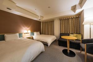 Un pat sau paturi într-o cameră la Utsunomiya Tobu Hotel Grande