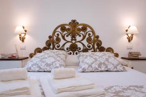 a bedroom with a bed with two towels on it at B&B Toma Street in Lecce
