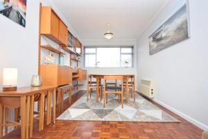 a kitchen with a table and chairs in a room at Sea Breeze, Selsey in Selsey