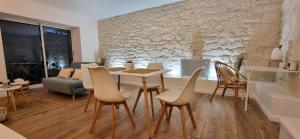 a living room with a table and chairs and a couch at Le P'tit Bohème, Terrasse privative. in Lanester