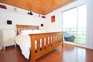a bedroom with a bed and a large window at 4 Avocet Quay , Emsworth in Emsworth
