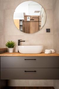 a bathroom with a sink and a mirror at Apartament Nakielska 46a lux 40m2 in Bydgoszcz +36 photos