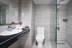 a bathroom with a toilet, sink, and shower at Mayfair Hotel formerly Smartline Paphos in Paphos