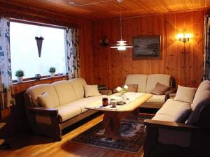 a living room with two white couches and a table at Apartment STRYN in Stryn
