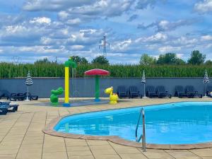 - une piscine avec un parasol et des chaises dans l'établissement Smart Home Venezia mit Terrasse, Europapark, Rulantica 15min, à Boofzheim