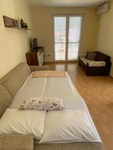 ein Wohnzimmer mit einem Sofa und einem Kissen darauf in der Unterkunft Apartman Perovic in Kotor