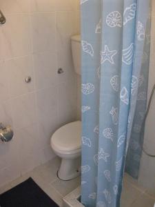 a bathroom with a toilet and a shower curtain at Villa San Marco in Budva