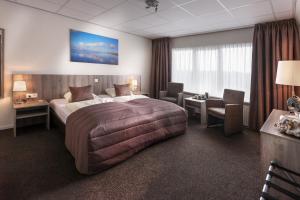 Rúm í herbergi á SEA YOU Hotel Noordwijk