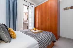 a bedroom with a bed with a tray on it at Fridays Flats Whisper-quiet Near Sagrada's Heart in Barcelona