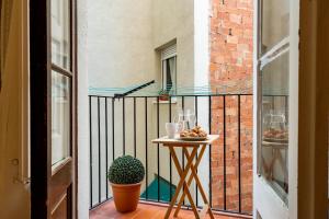 a balcony with a table with a bowl of food on it at Whisper-quiet Near Sagrada's Heart in Barcelona