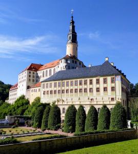 a large building with a tower on top of it at FeWo Wünschendorf in Dürrröhrsdorf