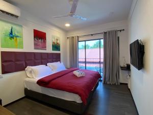 1 dormitorio con 1 cama grande y TV en chillax Thoddoo, en Thoddoo
