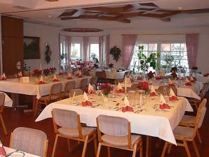 a banquet hall with white tables and chairs at Zum Ochsen in Hauenstein