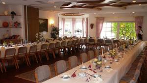 a large banquet hall with long tables and chairs at Zum Ochsen in Hauenstein