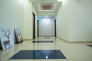 a hallway with white walls and a tile floor at Hope Hotel Masai in Masai +46 photos