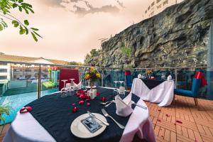 a room with a table and chairs on a balcony at PrideInn Azure Hotel Nairobi Westlands in Nairobi