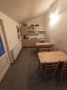 a kitchen with tables and chairs in a room at Penzion U Tomanů in Jaroměřice na Rokytné