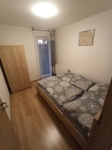 a bedroom with a bed and a wooden floor at Penzion U Tomanů in Jaroměřice na Rokytné