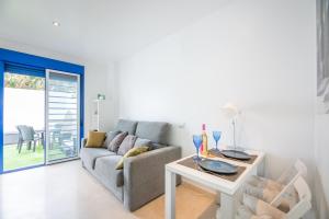 a living room with a couch and a table at MODERN APARTMENT NEXT TO THE BEACH, Pets friendly in Benalmádena