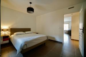 a bedroom with a large bed and a hallway at Apartment Montaigne in Cannes