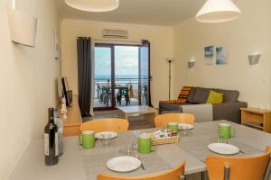 a kitchen and living room with a table and chairs at The Family Apart Beach in Ericeira