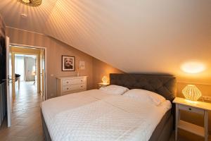 a bedroom with a large bed with white sheets at Wohnpark Stadt Hamburg by Rujana in Binz
