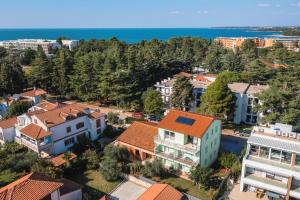 an aerial view of a town with houses and the ocean at ANDREA house with apartments in Umag