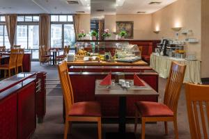 a restaurant with a table and chairs and a buffet at Residenz Hotel Detmold in Detmold