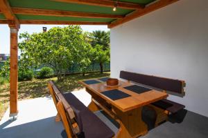 a wooden table and chairs on a patio at Little House Orebić in Orebić