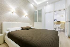 a bedroom with a large bed and a dining room at Center Avenue Apartments in Vilnius